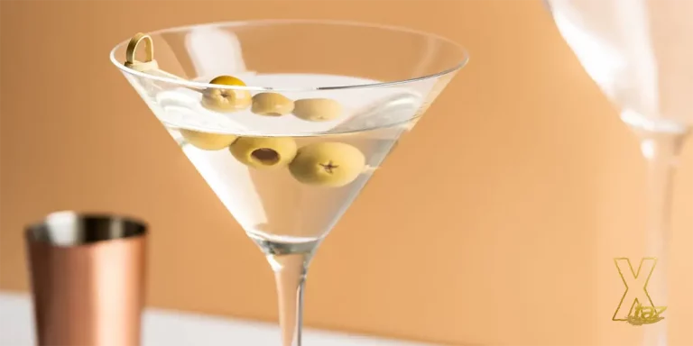 A glass with Vodka Martini on orange background.